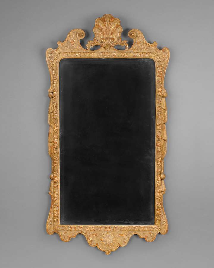 A GEORGE I CARVED GESSO AND GILTWOOD WALL MIRROR
